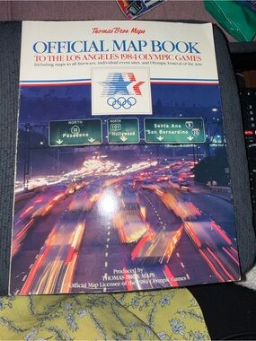 Source Unknown Official Map Book - White & Blue Cover with Red Accents